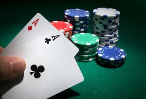 5081205-looking-at-pocket-aces-during-a-poker-game